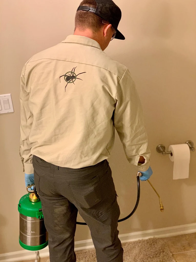 RECON Pest Services technician performing an indoor fly control treatment inside a home using professional pest control equipment to eliminate flies and protect against common household pests.