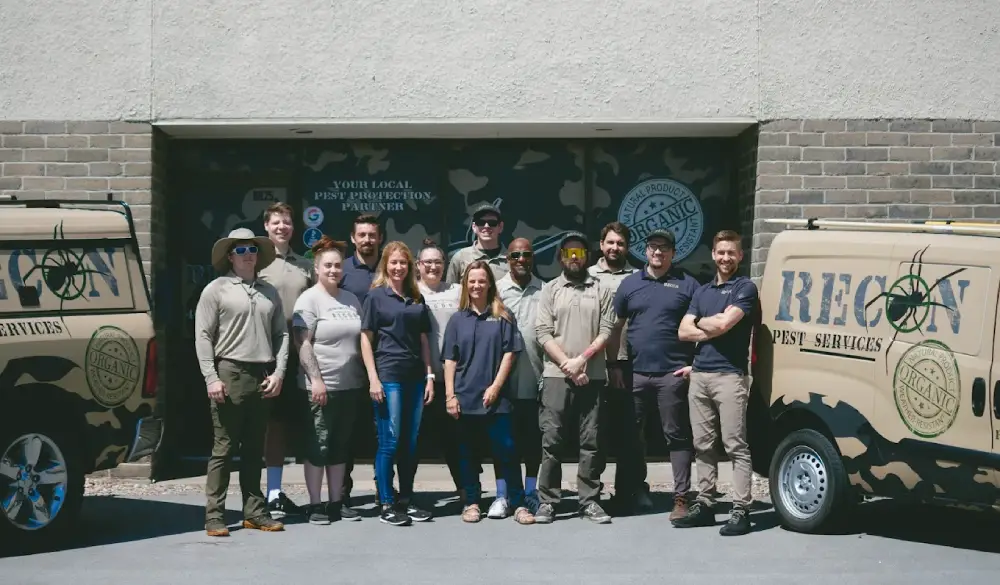 The RECON Pest Services team standing outside their Omaha office with company  service vehicles, showcasing local pest control professionals serving Nebraska  homeowners and businesses.